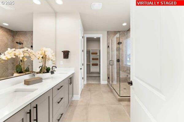 10494 SE Reverent Rd Unit 315, Happy Valley, OR 97086 - bathroom with double vanity, recessed lighting, a spacious closet, a sink, and a stall shower
