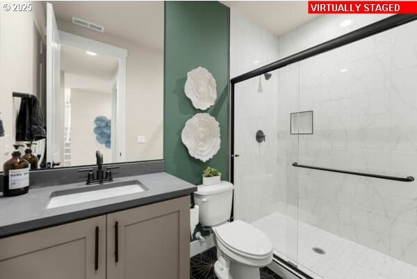 10494 SE Reverent Rd Unit 315, Happy Valley, OR 97086 - full bathroom featuring vanity, toilet, visible vents, and a stall shower