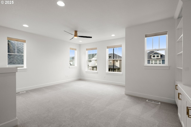 carpeted empty room featuring ceiling fan