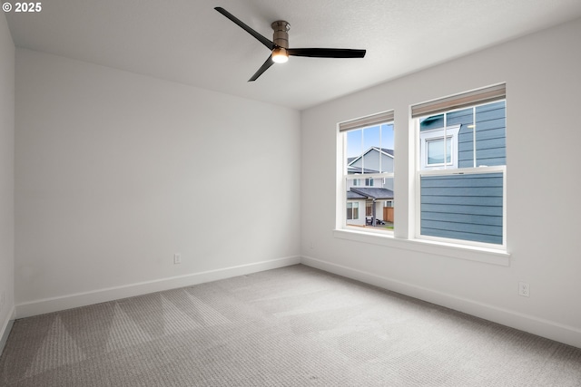 empty room with ceiling fan and carpet