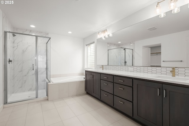 bathroom with vanity and independent shower and bath