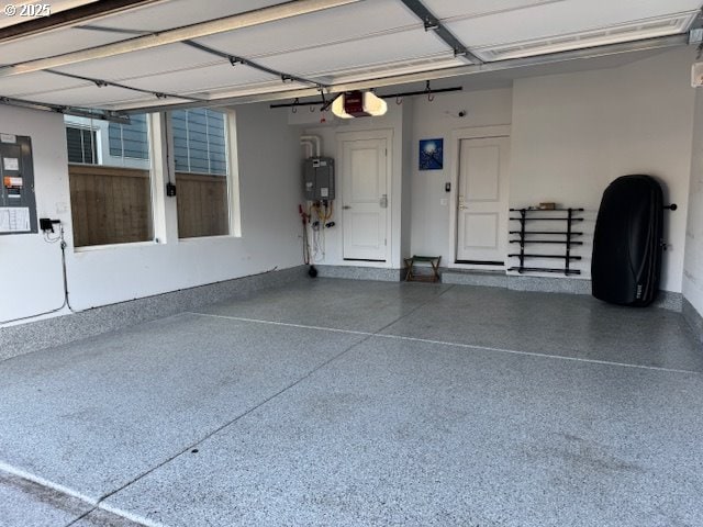 garage with electric panel, water heater, and a garage door opener