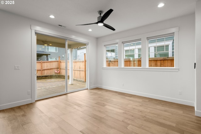 unfurnished room with ceiling fan and light hardwood / wood-style floors