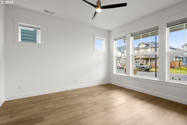 empty room featuring ceiling fan and light hardwood / wood-style flooring