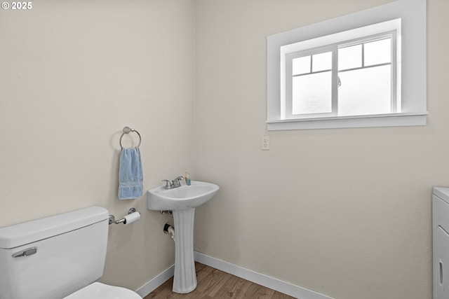 245 NE Balm St, Sheridan, OR 97378 - bathroom featuring toilet, baseboards, and wood finished floors