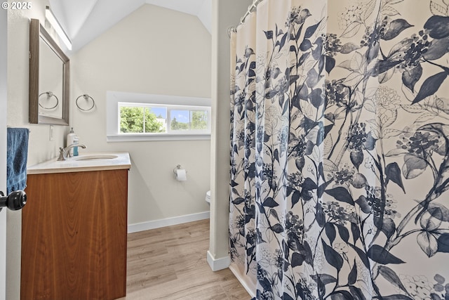 245 NE Balm St, Sheridan, OR 97378 - full bathroom featuring lofted ceiling, vanity, wood finished floors, toilet, and baseboards
