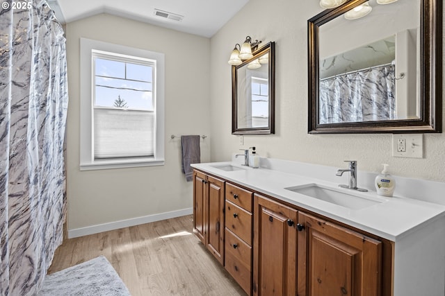 245 NE Balm St, Sheridan, OR 97378 - full bath featuring double vanity, wood finished floors, vaulted ceiling, and baseboards
