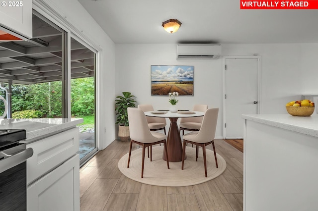 dining room featuring light wood-type flooring and a wall mounted AC