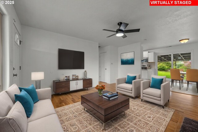 living area featuring ceiling fan and light wood-style flooring