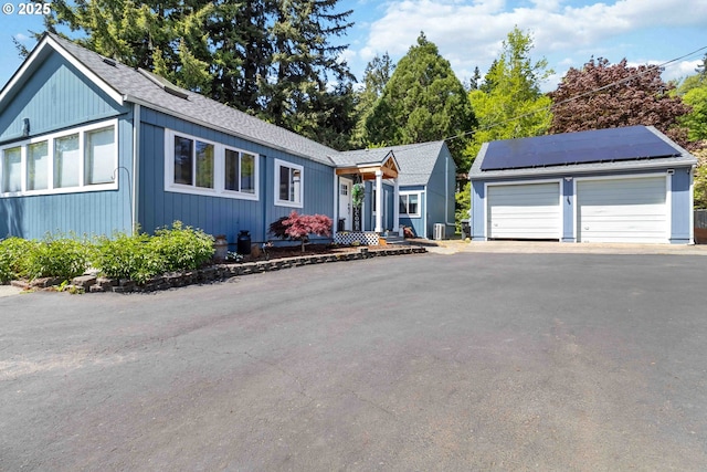 2337 W Castleman St, Longview, WA 98632 - single story home with a detached garage, a shingled roof, and solar panels