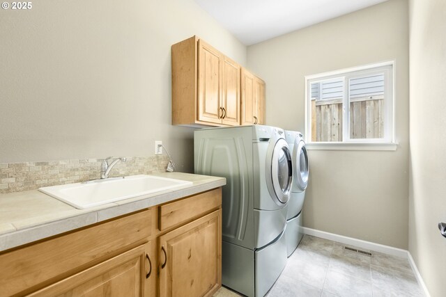 3678 Snowberry Rd, Eugene, OR 97403 - laundry area featuring washing machine and clothes dryer, cabinet space, baseboards, and light tile patterned floors
