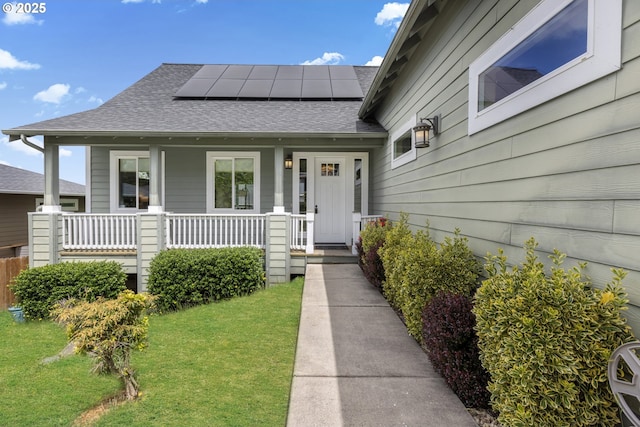 3678 Snowberry Rd, Eugene, OR 97403 - property entrance featuring a shingled roof, roof mounted solar panels, a porch, and a yard
