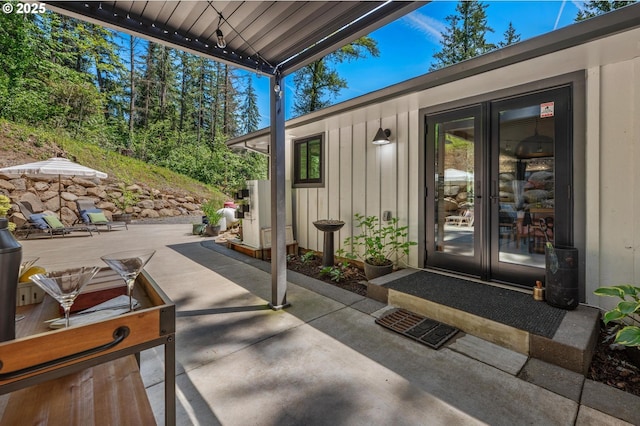 19919 SE Borges Rd, Damascus, OR 97089 - view of exterior entry featuring board and batten siding and a patio