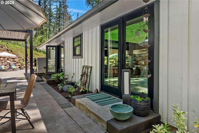 19919 SE Borges Rd, Damascus, OR 97089 - doorway to property featuring board and batten siding, a patio, and french doors