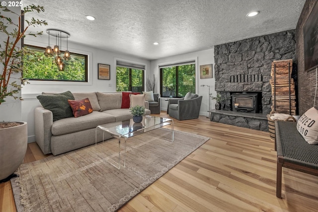19919 SE Borges Rd, Damascus, OR 97089 - living area with a textured ceiling, wood finished floors, a fireplace, recessed lighting, and baseboards