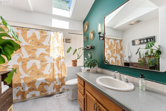 16511 NE Wasco St, Portland, OR 97230 - full bath with vanity, tile patterned flooring, a skylight, a shower with shower curtain, and lofted ceiling