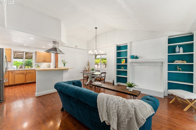 16511 NE Wasco St, Portland, OR 97230 - living area featuring a chandelier, vaulted ceiling, healthy amount of natural light, and wood finished floors