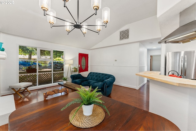 16511 NE Wasco St, Portland, OR 97230 - dining room with lofted ceiling, wood finished floors, and a chandelier