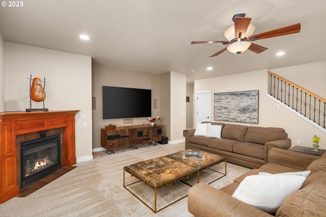 living room featuring stairway, a ceiling fan, recessed lighting, and light colored carpet