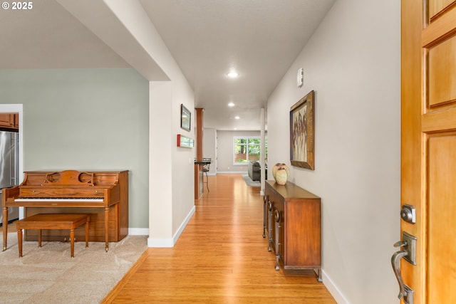 corridor with recessed lighting, baseboards, and light wood-style flooring