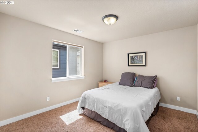 carpeted bedroom with baseboards