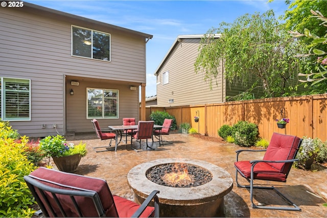 view of patio featuring a fire pit and a fenced backyard