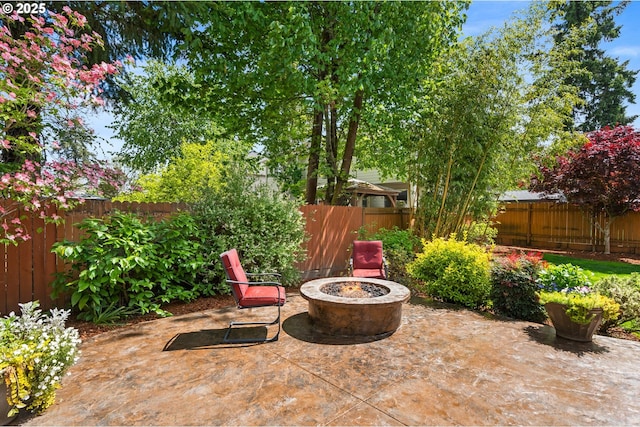 view of patio featuring a fenced backyard and a fire pit