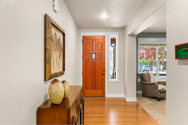 foyer entrance with baseboards and light wood finished floors