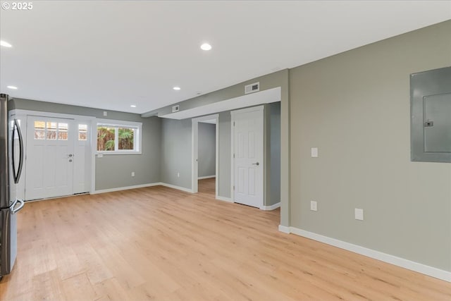 2706 SE Spruce St, Hillsboro, OR 97123 - unfurnished living room featuring electric panel, light wood-style floors, baseboards, and recessed lighting