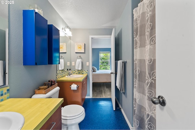 6708 N Pittsburg Ave, Portland, OR 97203 - full bathroom featuring connected bathroom, vanity, a textured ceiling, toilet, and wood finished floors