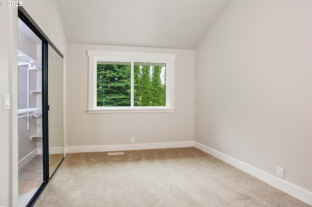 33500 E Bell Rd, Corbett, OR 97019 - unfurnished bedroom featuring carpet floors, vaulted ceiling, a closet, and a textured ceiling