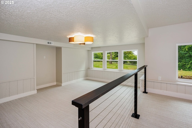 33500 E Bell Rd, Corbett, OR 97019 - hallway featuring carpet floors, a textured ceiling, and a wainscoted wall