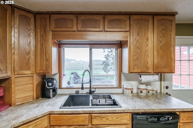 31501 Stoltz Hill Rd, Lebanon, OR 97355 - kitchen with black dishwasher, a sink, light countertops, and brown cabinetry