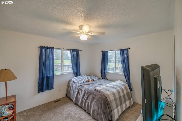 31501 Stoltz Hill Rd, Lebanon, OR 97355 - bedroom featuring multiple windows, light colored carpet, a textured ceiling, and ceiling fan