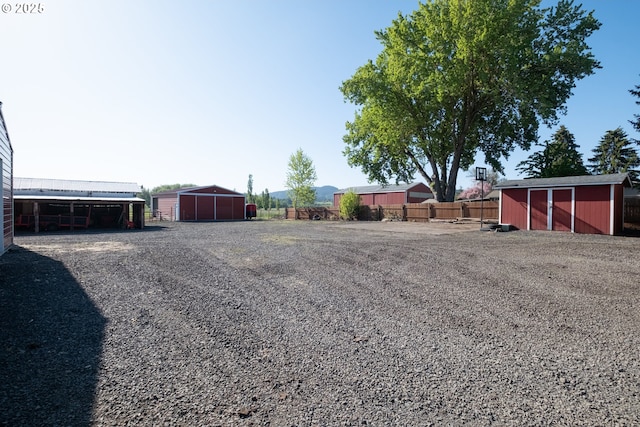 31501 Stoltz Hill Rd, Lebanon, OR 97355 - view of yard featuring fence, an outdoor structure, and an outbuilding