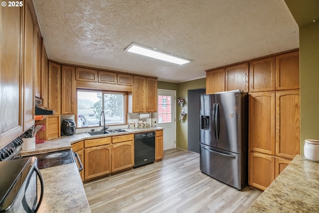 31501 Stoltz Hill Rd, Lebanon, OR 97355 - kitchen featuring stainless steel fridge with ice dispenser, black dishwasher, a sink, light countertops, and light wood-style floors