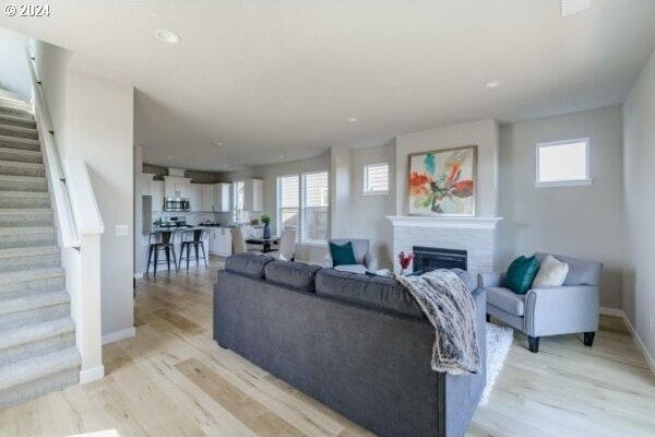 1587 N Millican Creek St, Lafayette, OR 97127 - living room with stairway, light wood-style flooring, a fireplace, healthy amount of natural light, and recessed lighting