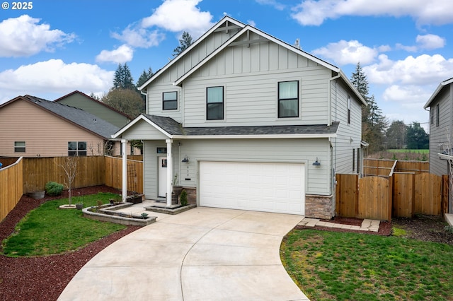 traditional-style house with board and batten siding, concrete driveway, an attached garage, and fence