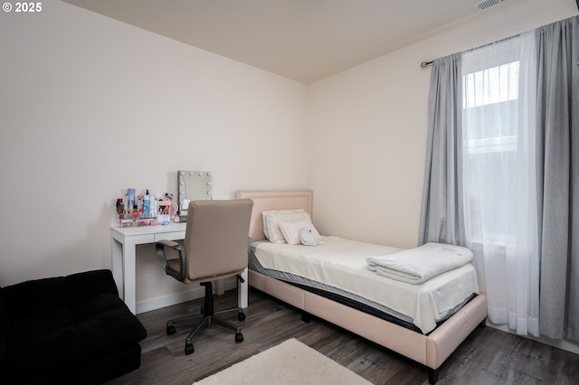 bedroom featuring visible vents and wood finished floors