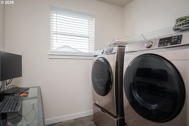 washroom with laundry area, separate washer and dryer, dark wood-type flooring, and baseboards