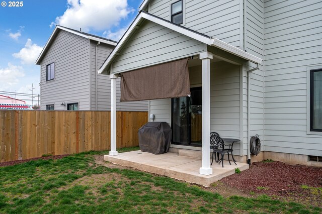 back of house with a yard, a patio, and fence