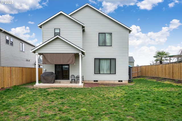 back of house with a patio, a lawn, a fenced backyard, and crawl space