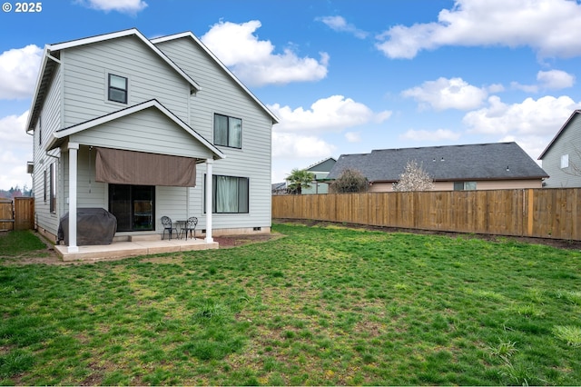 rear view of house featuring a patio, a lawn, a fenced backyard, and crawl space