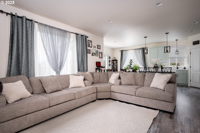 living area with recessed lighting and dark wood-style flooring