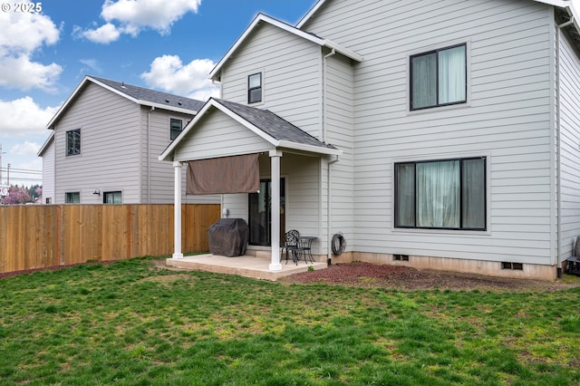 back of house with a yard, a patio, and fence