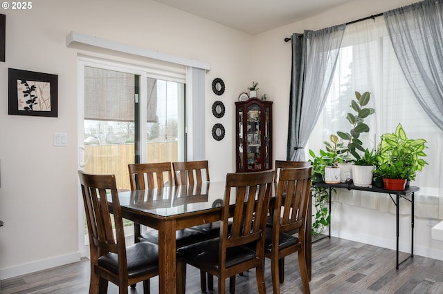 dining room with baseboards and wood finished floors