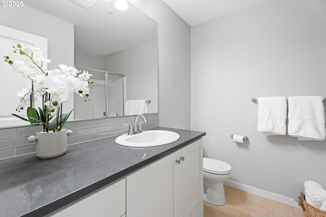 bathroom featuring tasteful backsplash, a shower stall, toilet, tile patterned floors, and vanity