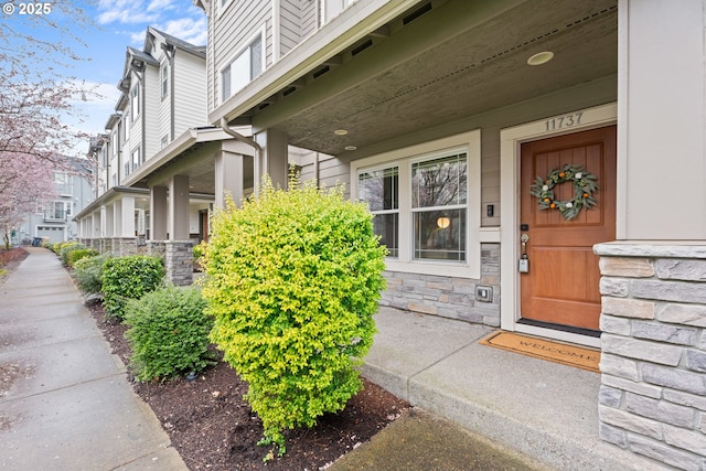 entrance to property featuring stone siding