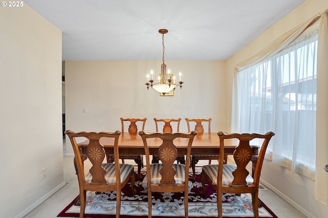 1545 NE Gertz Rd, Portland, OR 97211 - dining area featuring a chandelier, baseboards, and light carpet