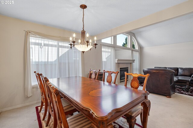 1545 NE Gertz Rd, Portland, OR 97211 - dining room with light colored carpet, a chandelier, lofted ceiling, and a fireplace